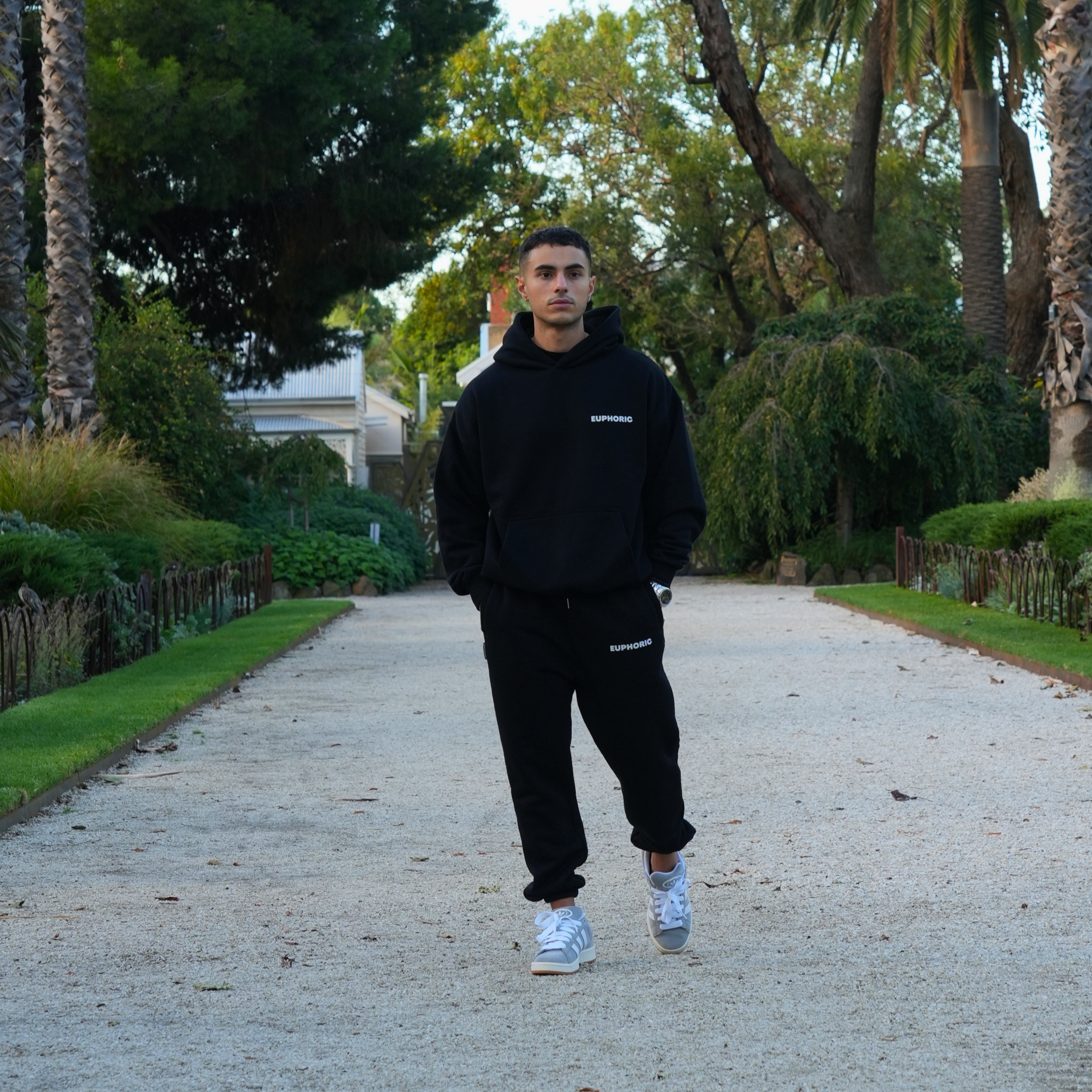 Model wearing black Euphoric tracksuit set outdoors