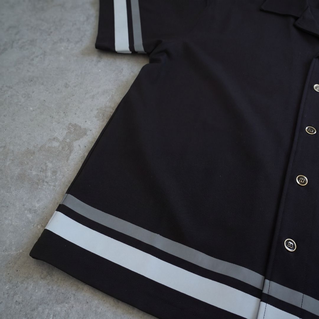 close up of euphoric relaxed button shirt, showcasing buttons, bottom and sleeve stripes