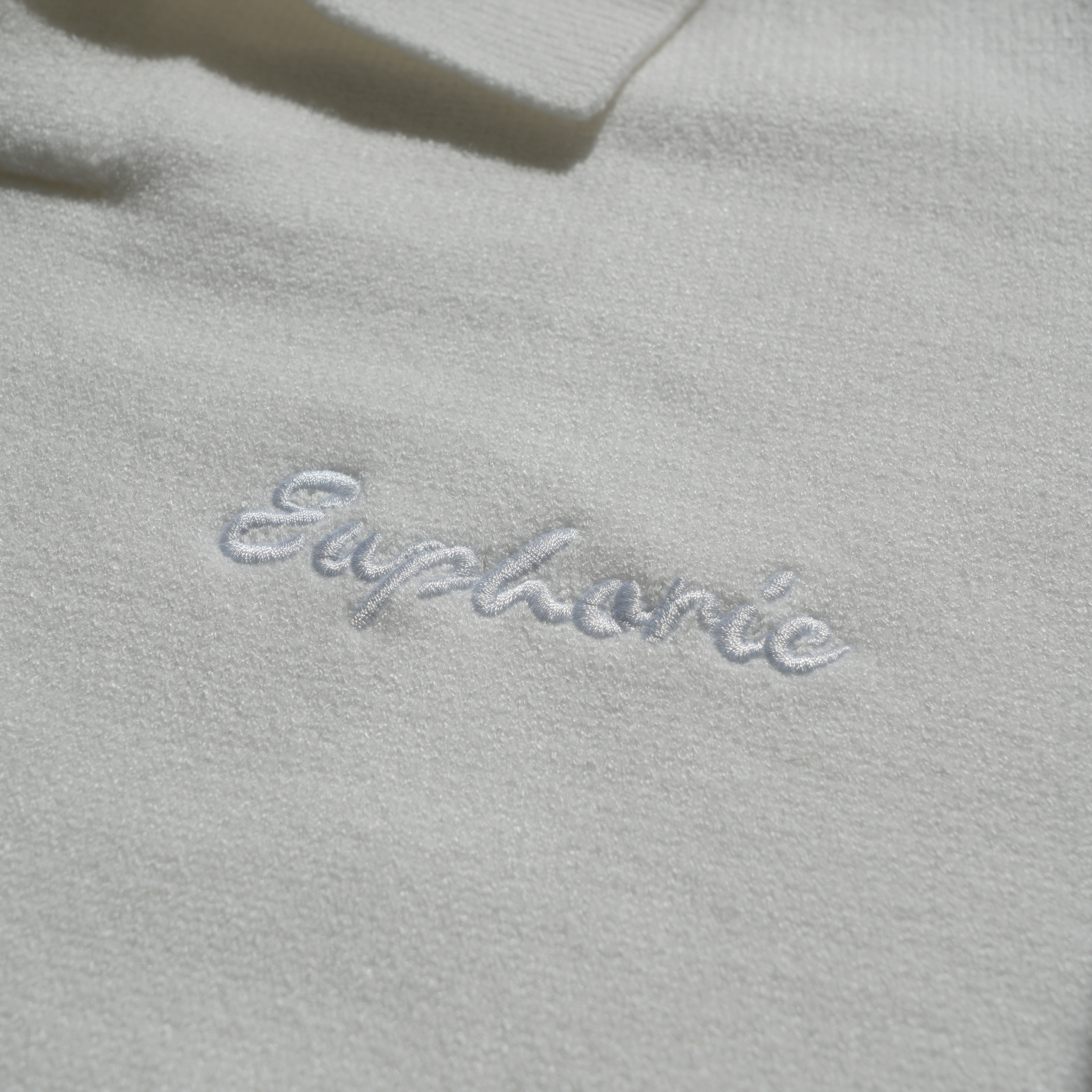 close up of euphoric polo shirt front embroidered logo
