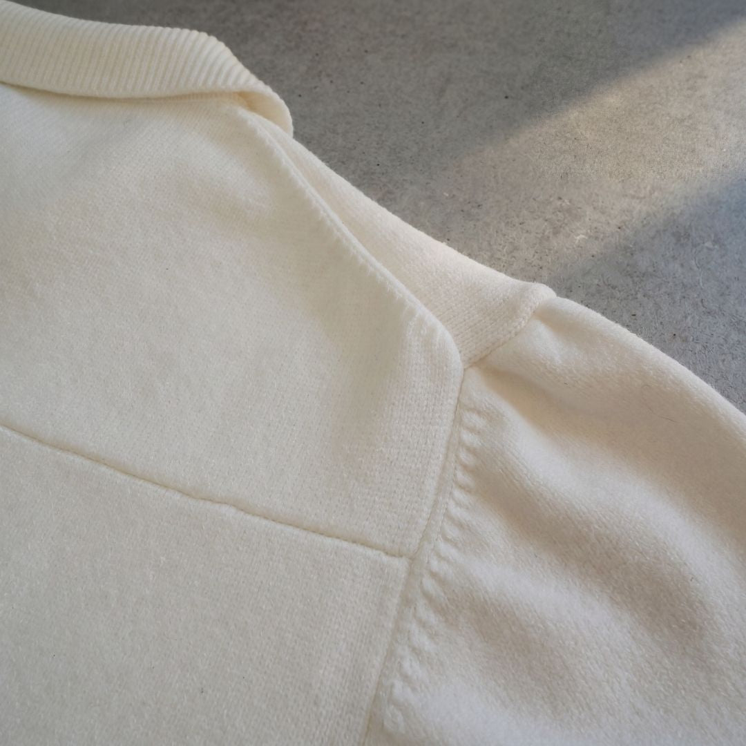 Euphoric pearl white polo shirt collar and shoulder seam construction on concrete floor background