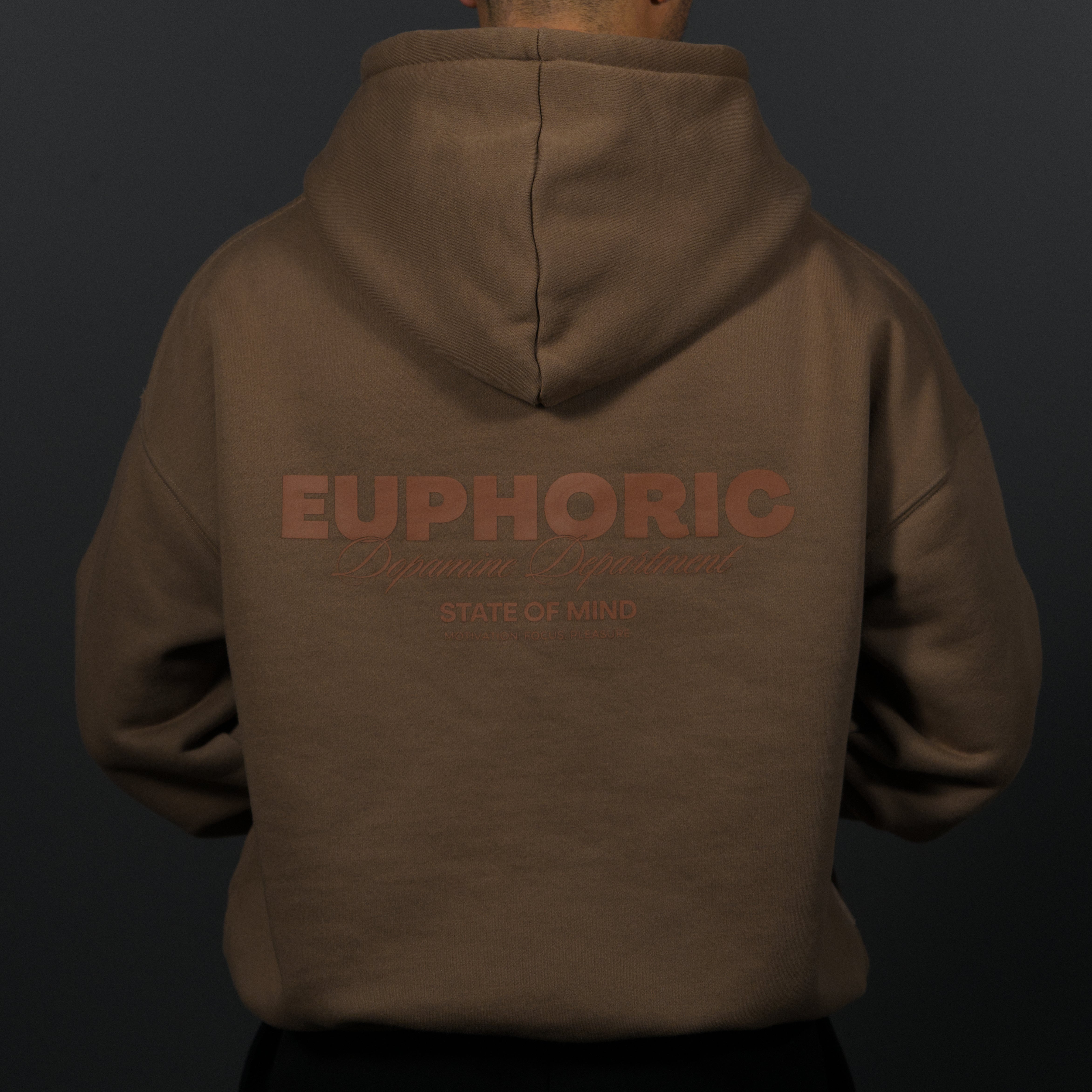A person viewed from the back wearing a brown hoodie with a tonal brown graphic on the back reading 'EUPHORIC Dopamine Department' and 'STATE OF MIND' against a dark gray background.